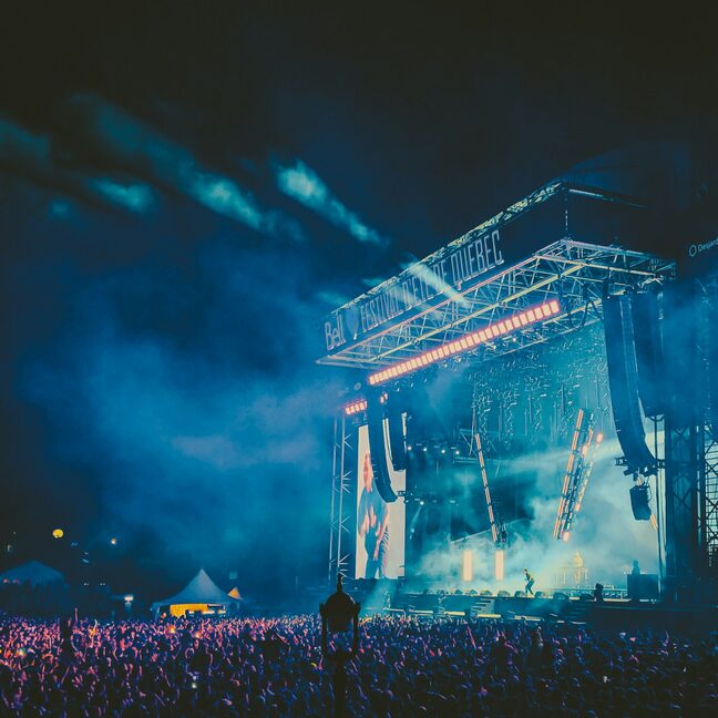 A stage lighting rig glowing through haze